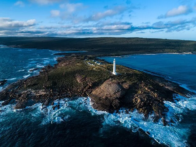 Aerial view of Cape Leeuwin Lighthouse and its rugged coastal surroundings.